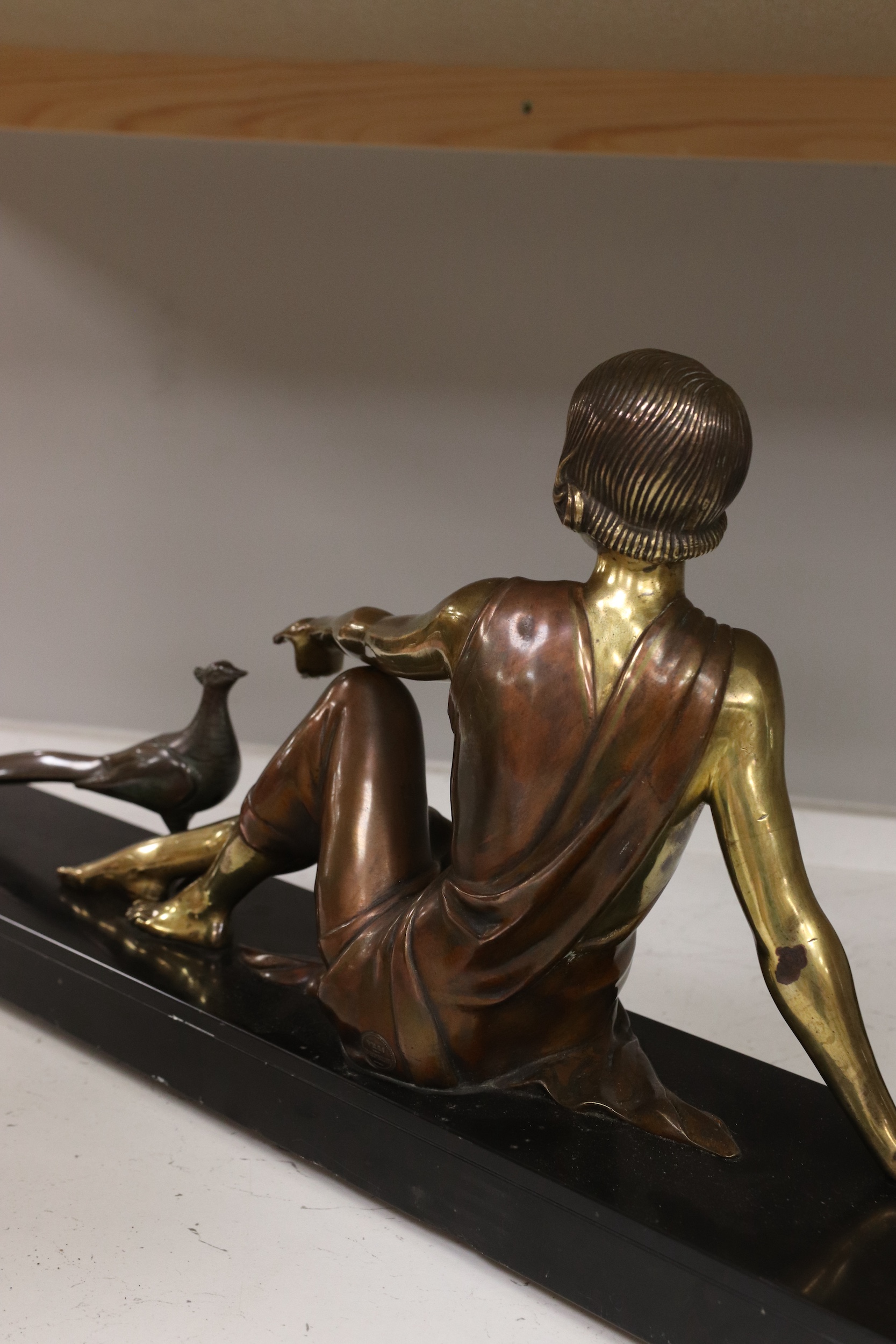 An Art Deco figural bronze of a girl with a peacock, VRAI Bronze foundry mark, signed Godard, on a marble base, base 65cm long, 30cm high. Condition - fair to good